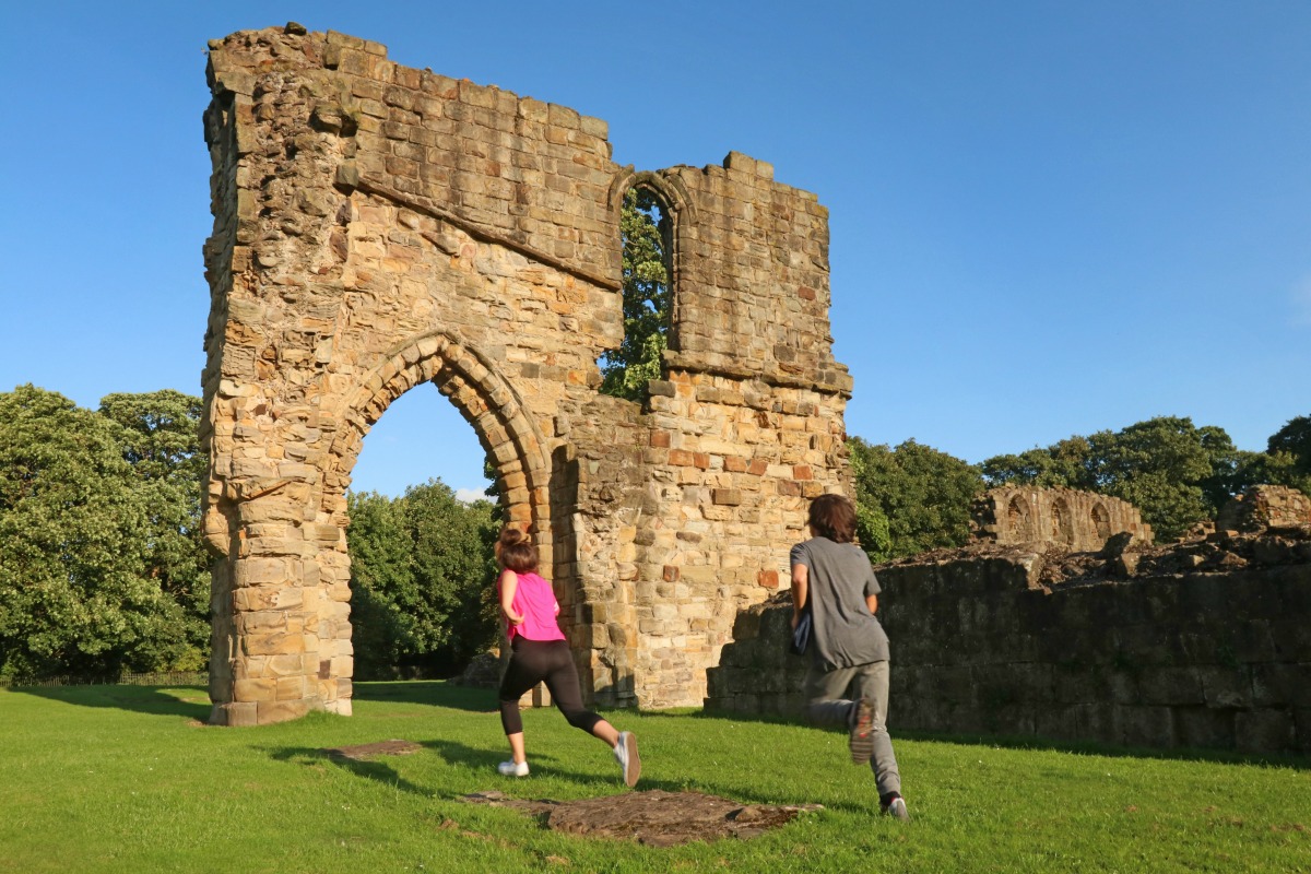 Madison Aldridge and Bernard Aldridge race around the abbey at Greenfield Heritage Park.